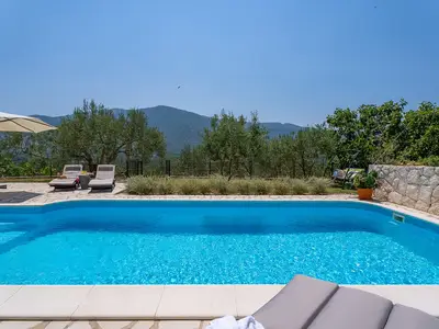 Sun deck area with 4 deck chairs and private pool
