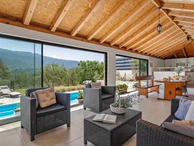 Fully equipped summer kitchen with barbecue and covered area for dining and sitting