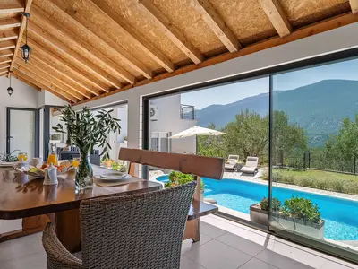 Fully equipped summer kitchen with barbecue and covered area for dining and sitting
