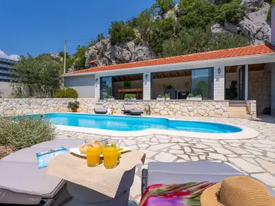 Sun deck area with 4 deck chairs and private pool
