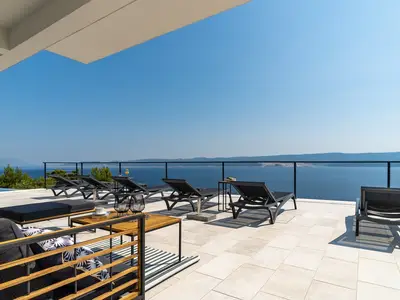 Spacious sun deck area with 8 deck chairs, 2 sun umbrellas, a lounge corner, an outdoor shower and a Table tennis