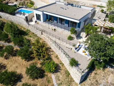 A fully air-conditioned 4-bedroom villa with free WiFi, spacious living area, fully equipped kitchen, a charming outdoor dining area and lounge corner,
