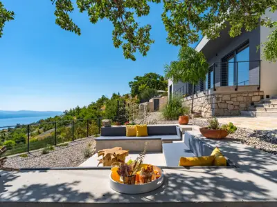 Lounge corner with an oak tree shade and spectacular sea views, which makes this a perfect spot for a glass of vine or a cup of coffee in the morning

