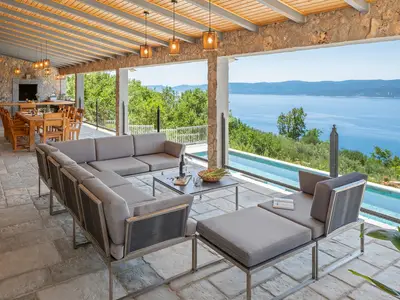 Outdoor dining area with a barbecue .