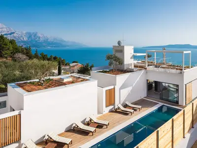 Eine Dachfläche (93 m2), die mit dem Aufzug oder einer Treppe erreichbar ist, bietet einen Grill, eine Küchenzeile mit Kühlschrank, einen überdachten Essbereich im Freien für 8 Personen und eine gemütliche Sitzecke.