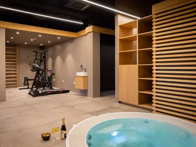 Stufe 1: Der Wellnessbereich von 89 m2 bietet ein Fitnessstudio mit einem multifunktionalen Trainingsgerät, einem Laufband und einem stationären Fahrrad.