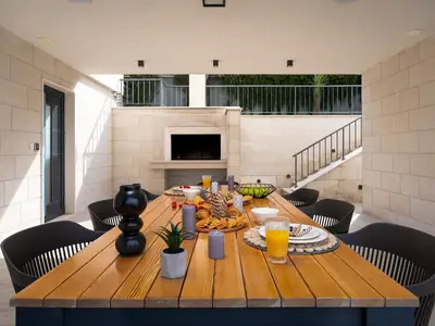 Outdoor, covered dining area connected with pool area
