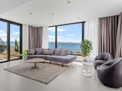 Living and dining area with  sea views, fire place, TV, exit to outdoor dining
