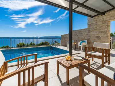 The outdoor sitting area next to the pool, amazing sea view