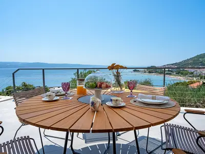 outdoor dining area with a sea view
