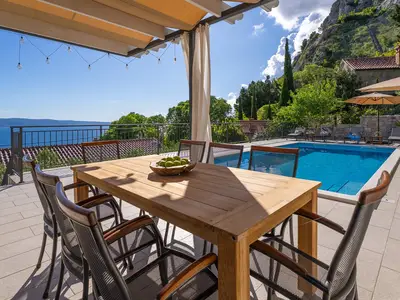 Outdoor dining area with an outdoor kitchen.