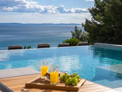 Comfortable sun deck area around the infinity pool with very comfortable sun-deck chairs
