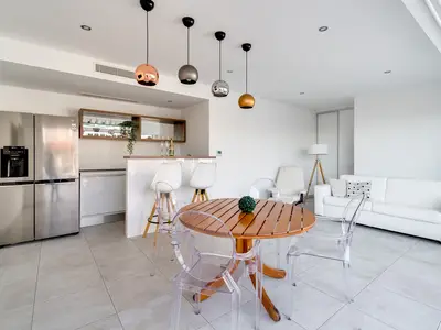 Modern summer kitchen and lounge area next to the pool