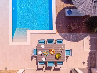 Voll ausgestattete Sommerküche und geräumiger Außenpoolbereich
