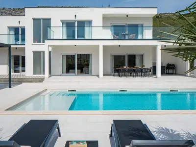 a large 47 m2 (10.5 m x 4.5 m) sparkling private pool with a ten loungers

